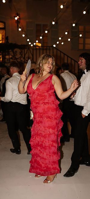 wedding guest wearing red ruffle dress for evening wedding celebrations