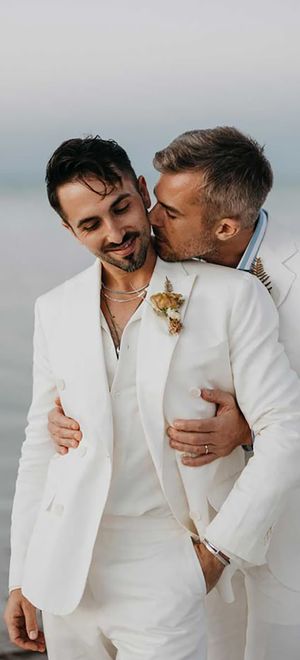 two grooms embracing at LGBT friendly mexico destination wedding