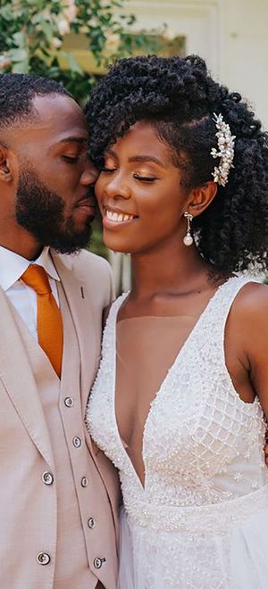 A bride with beautiful afro-kinky hair, styled with a delicate silver wedding hair accessory.