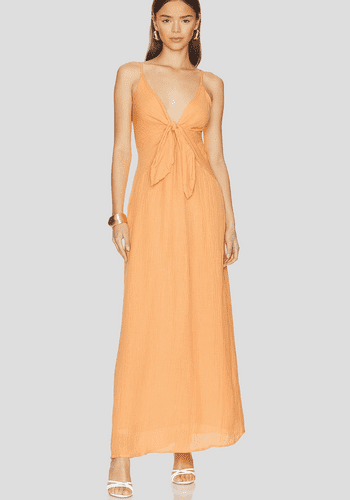 Peach bridesmaid dress from Faithfull the Brand/ Revolve with maxi length and front tie design 