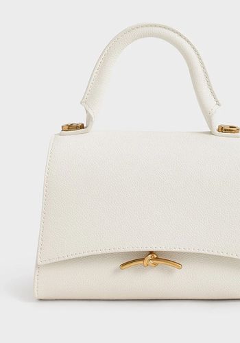 Cream bridal handbag from Charles &amp; Keith with gold metallic accents 