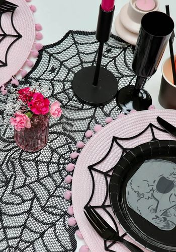 Gothic table decor for hen party theme with lace spider web table runner, black cups, candles and more