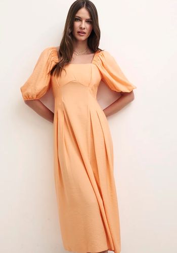 Orange peach bridesmaid dress from Nobody's Child with puff sleeves and midi length 