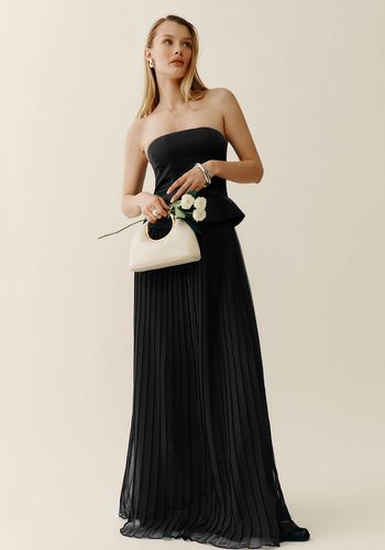 Black two piece wedding dress from Reformation with maxi pleated skirt and bandeau top