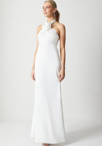 Casual and traditional beach wedding dress from Coast with halter neckline and floral corsage in satin material