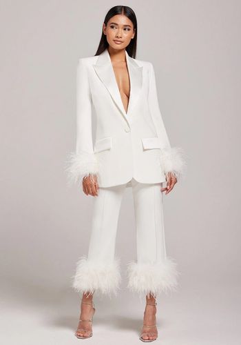 Bridal suit alternative wedding dress idea with feather trim from Nadine Merabi