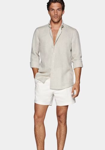 Beach wedding guest dress code outfit idea for men from Suit Supply - lightweight linen shirt and shorts