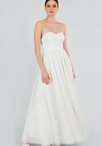 strapless princess wedding dress with layered full skirt, and sweetheart neckline.