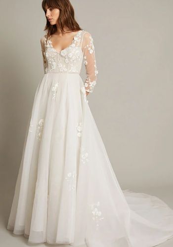 princess wedding dress with floral embroidery, pearl embellishments, long sleeves, and layered maxi skirt.