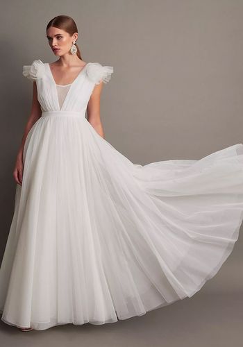 princess tulle wedding dress with full skirt and corsage details at the shoulder.