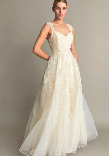 princess wedding dress with organza tulle volumious skirt, embroidered with cascading florals, and sweetheart neckline.