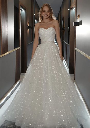 glittery sweetheart princess wedding dress with sparkling bow at the back