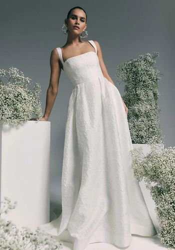 princess wedding dress with square neckline, fitted bodice, and full skirt.