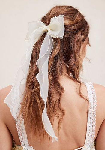 bridal hair accessory bow in ivory delicate, sheer fabrication.