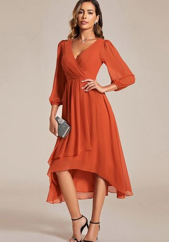 Burnt orange high low wedding guest dress with long sleeves and v neckline