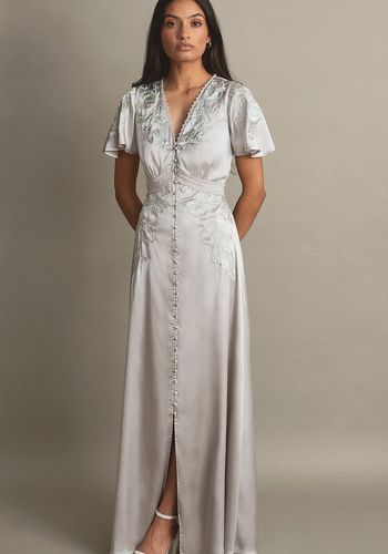 silver affordable bridesmaid dress from monsoon, with short flutter sleeves, a floaty maxi skirt, and lace detailing.