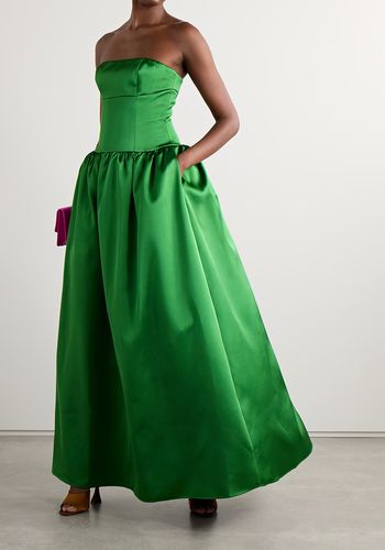 eye-catching green winter wedding guest dress, with fitted bodice and dramatic skirt lined with tulle