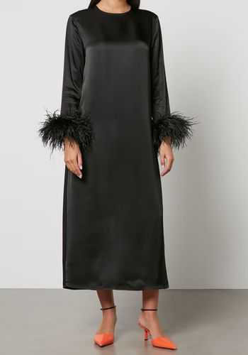 black ankle-length winter wedding guest dress with subtly padded shoulders and ostrich feathers trimmed cuffs.