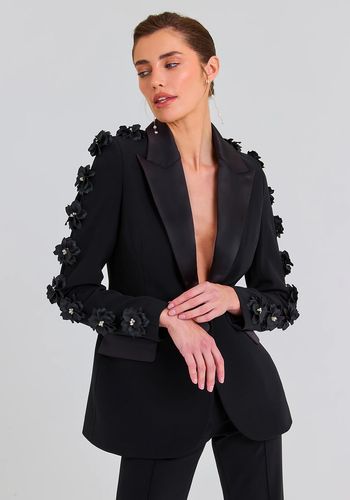 black bridal suit from nadine merabi for alternative black bridal outfit. Blazer features large floral appliqués down both sleeves