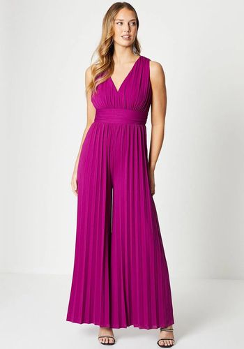 slinky jersey wedding guest jumpsuit in berry tone with plunge neckline and wide leg pleated trousers. 