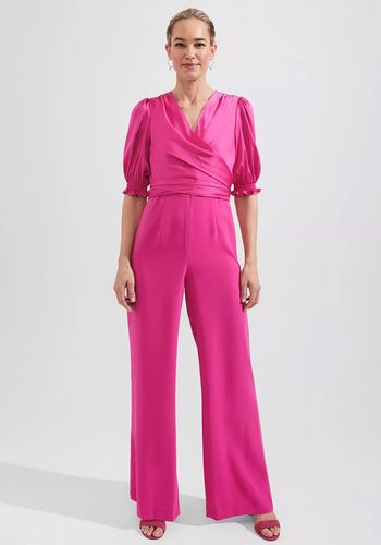 pink wedding guest jumpsuit with v-neck and short sleeves.