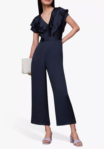 navy wedding guest jumpsuit with v-neckline and cap sleeves and ruffled bodice.