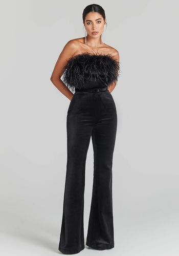 black velvet wedding guest jumpsuit with feather trim.