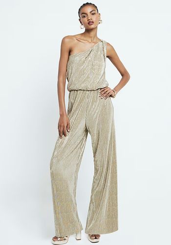 gold metallic wedding guest jumpsuit in plisse material and asymmetric neckline.