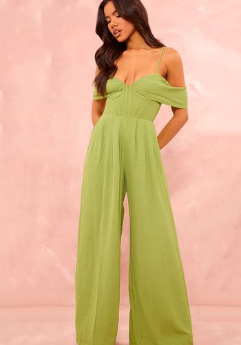  sage green wedding guest jumpsuit with a corset detail and a draped, wide leg design.