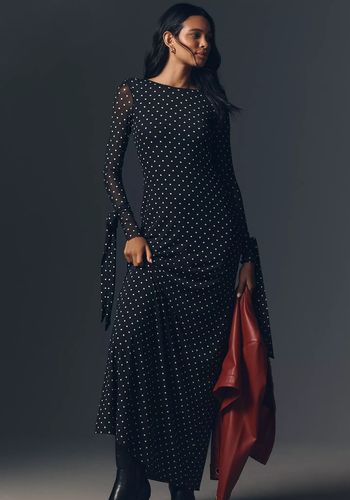 black and white polka dot long sleeve wedding guest dress with long sleeves, open back and tie cuff details.