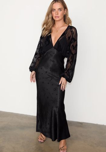 black long sleeve wedding guest dress with sheer sleeves and swallow print. 