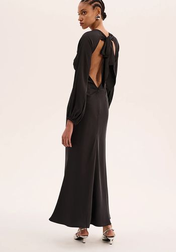 black satin long sleeve wedding guest dress with balloon sleeves and open back with sash detail.