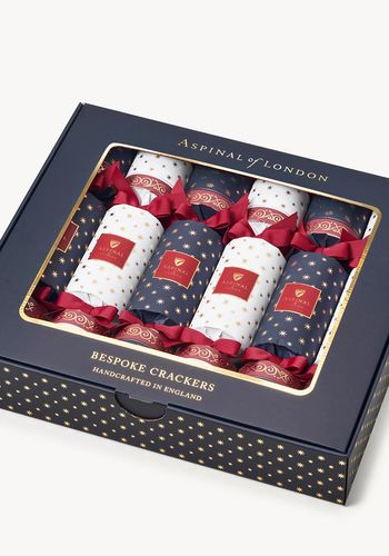 set of six luxury christmas crackers from Aspinal of London, including a chic leather bookmark, elegant keyrings, and our artisanal Aspinal honey.