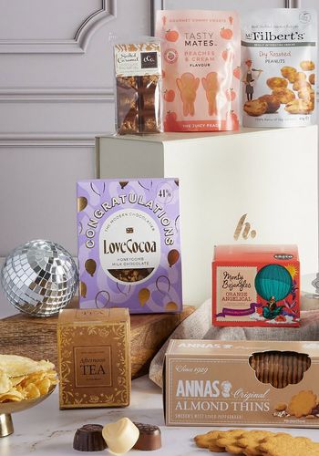 congratulations hamper as engagement gift idea, full of food and snacks, including biscuits, chocolate, crisps and more.