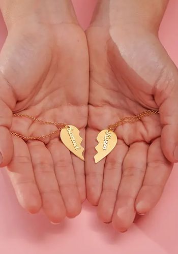 personalised couples necklace with initials and date in two halves of a heart design for engagement gift. 