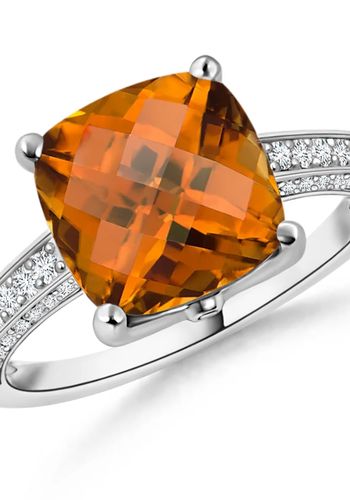 cocktail ring showcases a GIA certified yellowish orange zircon in a classic prong setting.