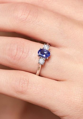 white gold engagement ring, featuring single tanzanite gemstone with two diamonds either side.