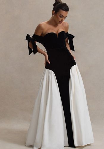 black velvet wedding dress, featuring boned corset bodiced with bows, sweetheart bardot neckline, and cream volume skirt. 