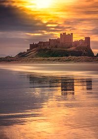 Coastal castle at sunset overlooking the sea in North East England