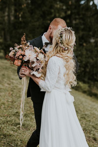 Dolomites Wedding on a mountain top with autumnal wedding bouquet and flower crown