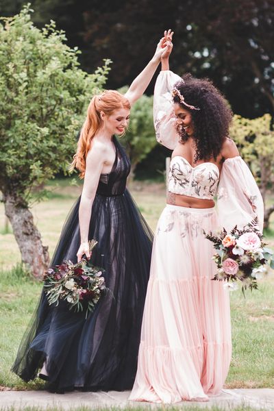 Autism marriage inclusive wedding inspiration with two brides in a black wedding dress and pink embroidered bridal separates