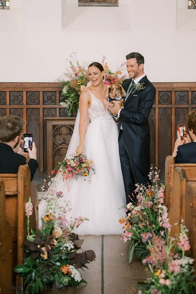 wedding wildflower arrangements decorate the aisle