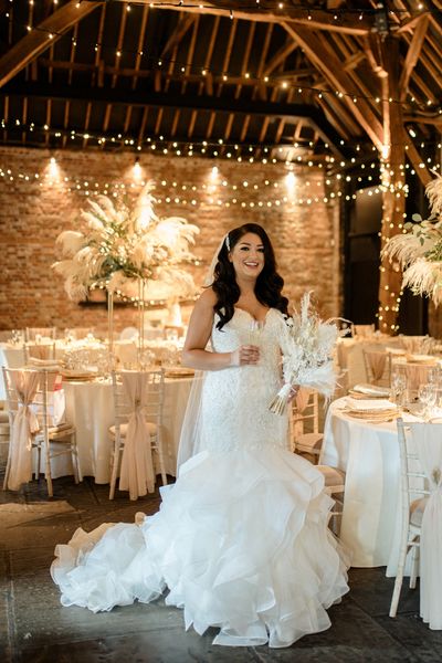 Intimate Cooling Castle Barn wedding with neutral colour scheme, dried flowers and fishtail wedding dress.