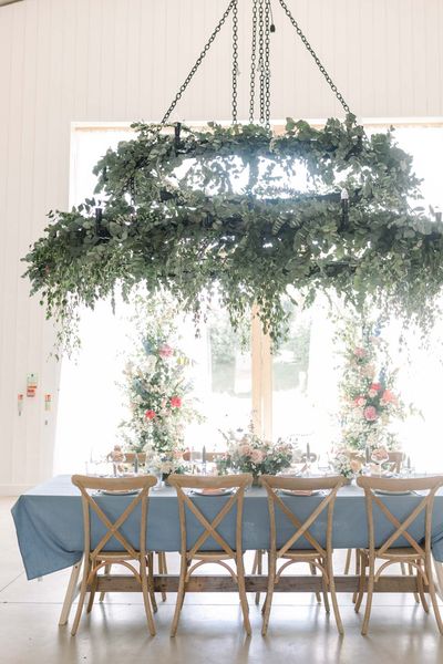 Pastel wedding inspiration at The White Barn in Somerset with vertical floral arrangements 