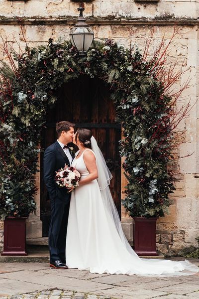 Bride and groom kiss at their Christmas Notley Abbey wedding!