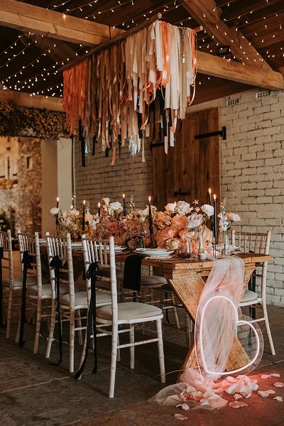 Eden Barn wedding with neon sign, fringe garland and black accent candles