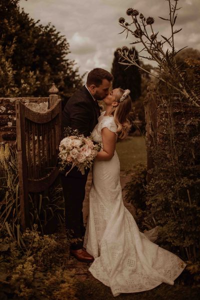 outdoor wedding at Dewsall court with bride in a lace cap sleeve wedding dress