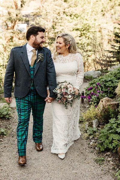 Tartan trousers and lace wedding dress for intimate Scottish pub wedding 