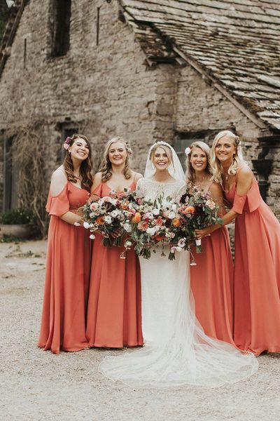 Bride with her bridesmaids in coral bridesmaid dresses from Rewritten Bridesmaids.