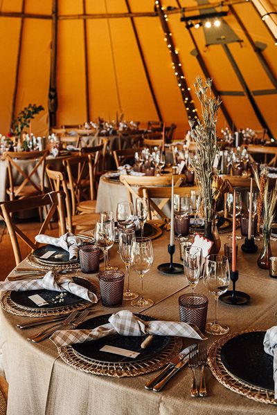 Tipi wedding with neutral wedding table decor and tablescape with warm lighting